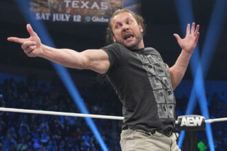Kenny Omega holds the AEW International title to fight against Okada Okada at Fighter Fest